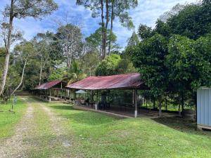 a building with a rusted roof in a park at Orchard Villa, Radiant Janda Baik in Bentong