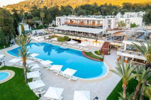 an aerial view of a resort with a swimming pool at DoubleTree by Hilton Bodrum Isil Club Ultra All-Inclusive Resort in Torba