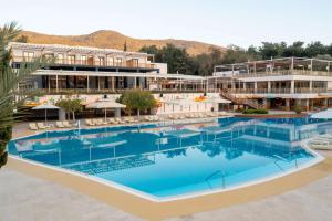 an aerial view of a hotel with a large swimming pool at DoubleTree by Hilton Bodrum Isil Club Ultra All-Inclusive Resort in Torba