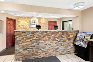 a lobby of a candy store with a brick wall at Quality Inn Cleveland Airport in Middleburg Heights