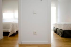 A bed or beds in a room at Casas Apartamentos Gracia