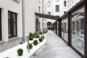a street with plants on the side of a building at Golden Tulip Krakow City Center in Kraków