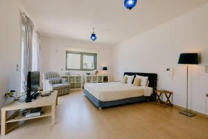 a bedroom with a bed and a television in it at Caza Bella Vista a Luxurious House in Kos Town