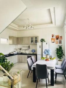 a kitchen with a table and chairs and a refrigerator at Say Homestay - Venuestay in Da Thien