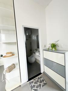 a bathroom with a toilet and a mirror at Say Homestay - Venuestay in Da Thien