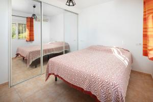 a bedroom with two beds and a mirror at Finca Carrion in Periana +25 photos