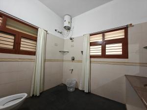 a bathroom with a toilet and a shower in it at 6bhk Luxury Villa in Mysore