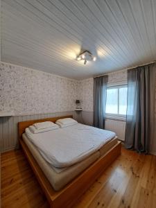 a bedroom with a large bed in a room at Reyers Bo På Landet in Vansbro