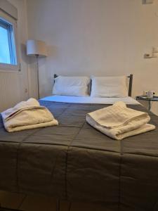 zwei Handtücher liegen auf einem Bett in der Unterkunft City Studio Kavala in Kavala