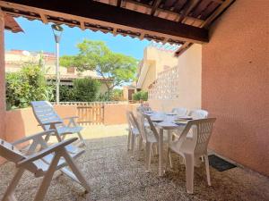 a table and chairs sitting on a patio at Maison Studio Mezzanine - Gruissan Ayguades AY060-A71 in Vires