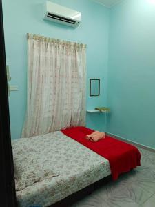 Postel nebo postele na pokoji v ubytování AFNAN Homestay