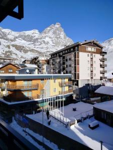 a city with snow covered mountains in the background at CERVINIA CITY CENTER in Breuil-Cervinia
