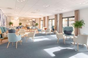 a waiting room with chairs and tables in a hospital at Résidence Angers in Angers