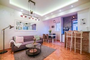 a living room with a couch and a table at Panorama Central Apartments in Belgrade