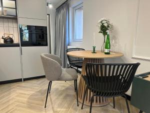 a kitchen with a table and chairs in a kitchen at Grand Pavilion in Bydgoszcz