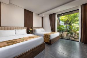 a hotel room with two beds and a window at Ecorest Villa Cat Ba Moutain View in Cat Ba +109 photos