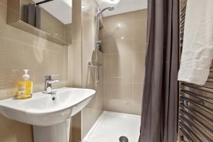 a bathroom with a sink and a shower at Stylish Apartment in Euston and near Camden with Private Roof Terrace in London