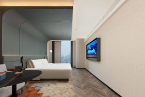 Televiisor ja/või meelelahutuskeskus majutusasutuses Atour S Hotel Wuhan Jiangchengtian Street Xinhua Road
