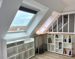 a room with white shelves and a window at L'Hippocampe, terrasse, à 5 min' à pieds de la mer ! in Wimereux