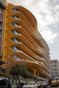 a yellow building with a curved facade at Classy Suite Taksim in Istanbul