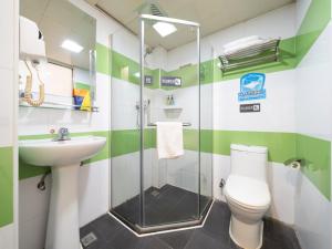 a bathroom with a shower and a toilet and a sink at 7Days Inn Railway Station Xi'an Wulukou Subway Station in Xi'an +31 photos