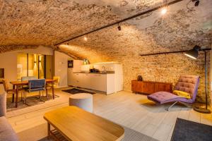 a large living room with a brick wall at Luxurious renovated apartment in Utrecht City center with view on the old canal in Utrecht +13 photos