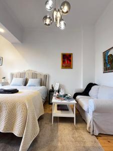 a living room with two beds and a couch at Christine's Apartment in Sofia