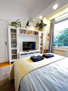 a bedroom with a bed with two towels on it at Christine's Apartment in Sofia +11 photos
