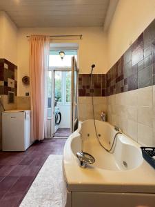 a large bathroom with a tub and a window at Christine's Apartment in Sofia