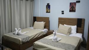 Postel nebo postele na pokoji v ubytování Good Season Hotel