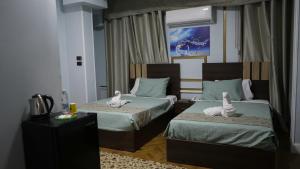 Postel nebo postele na pokoji v ubytování Good Season Hotel