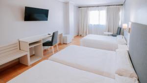 Postel nebo postele na pokoji v ubytování Hotel Bahia Sur