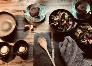a table with plates of food and bowls of salad at A casa dalla Tata B&B in Meina