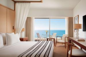 a hotel room with a bed and a view of the ocean at Tivoli Marina Vilamoura in Vilamoura