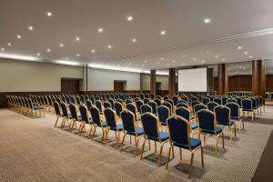 a room with rows of chairs and a screen at Tivoli Marina Vilamoura in Vilamoura