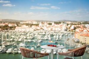 a table with a plate of fruit on top of a marina at Tivoli Marina Vilamoura in Vilamoura