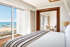 a bedroom with a bed with a view of the ocean at Tivoli Marina Vilamoura in Vilamoura