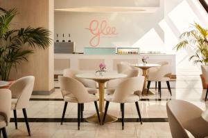 a restaurant with tables and chairs in a room at Tivoli Marina Vilamoura in Vilamoura
