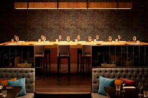 a dining room with a long table and chairs at Tivoli Marina Vilamoura in Vilamoura