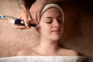 a woman getting her hair brushed with a hair dryer at Tivoli Marina Vilamoura in Vilamoura