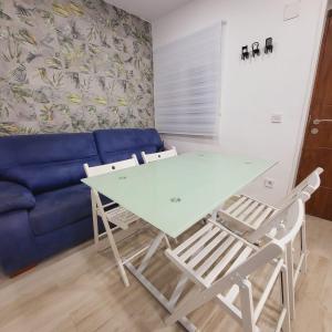 a table and chairs in a living room with a couch at Precioso Loft con Jacuzzi in Santander