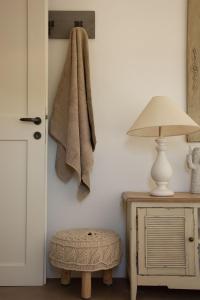 a towel hanging on a wall next to a lamp at Hacienda house in Andiparos +44 photos