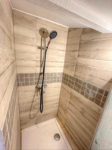 a shower with a shower head in a bathroom at Studio coeur du village, Lorgues in Lorgues