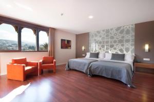 Postel nebo postele na pokoji v ubytování Hotel Granada Palace