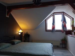 a bedroom with a bed and a window and a flag at Mansarda in Cluj-Napoca