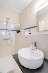 a bathroom with a white sink and a shower at Villa Amarilis in Casas Albardanera