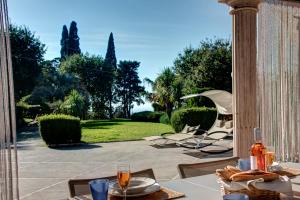 a table with food and drinks on a patio at Villa Demetra Capri - Pool and Relaxation in Anacapri