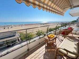 a balcony with a view of the beach at Condominio ADRIATICO in Bibione
