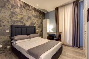 a bedroom with a large bed with blue walls at Residenza Belli Inn in Rome