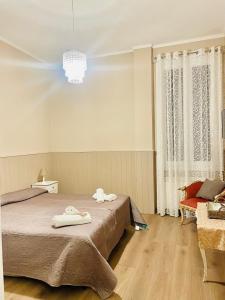 a bedroom with a bed with two towels on it at Nonna's Affittacamere in Sanremo